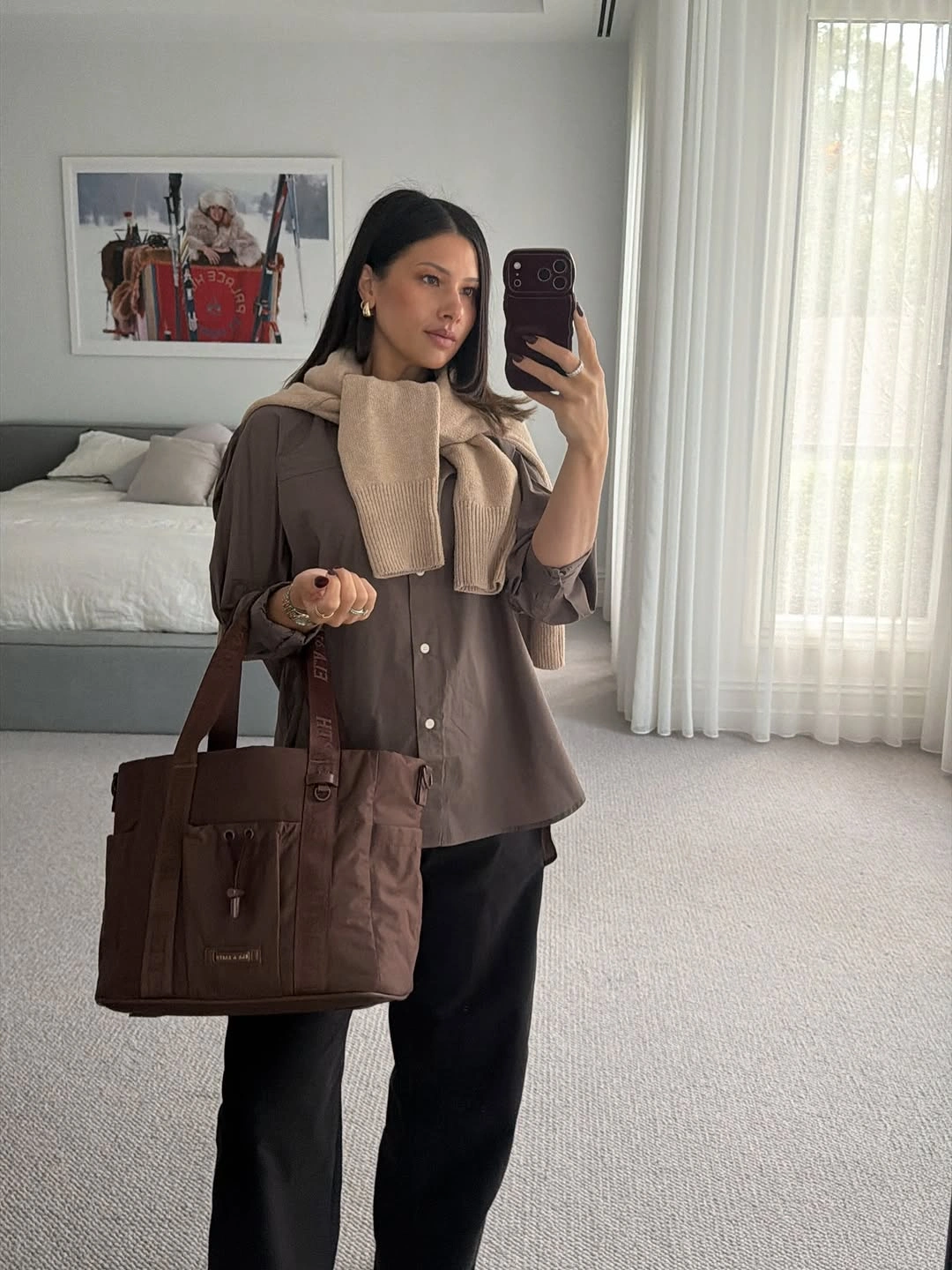 Brown blazer with cream scarf, black trousers, and brown work tote