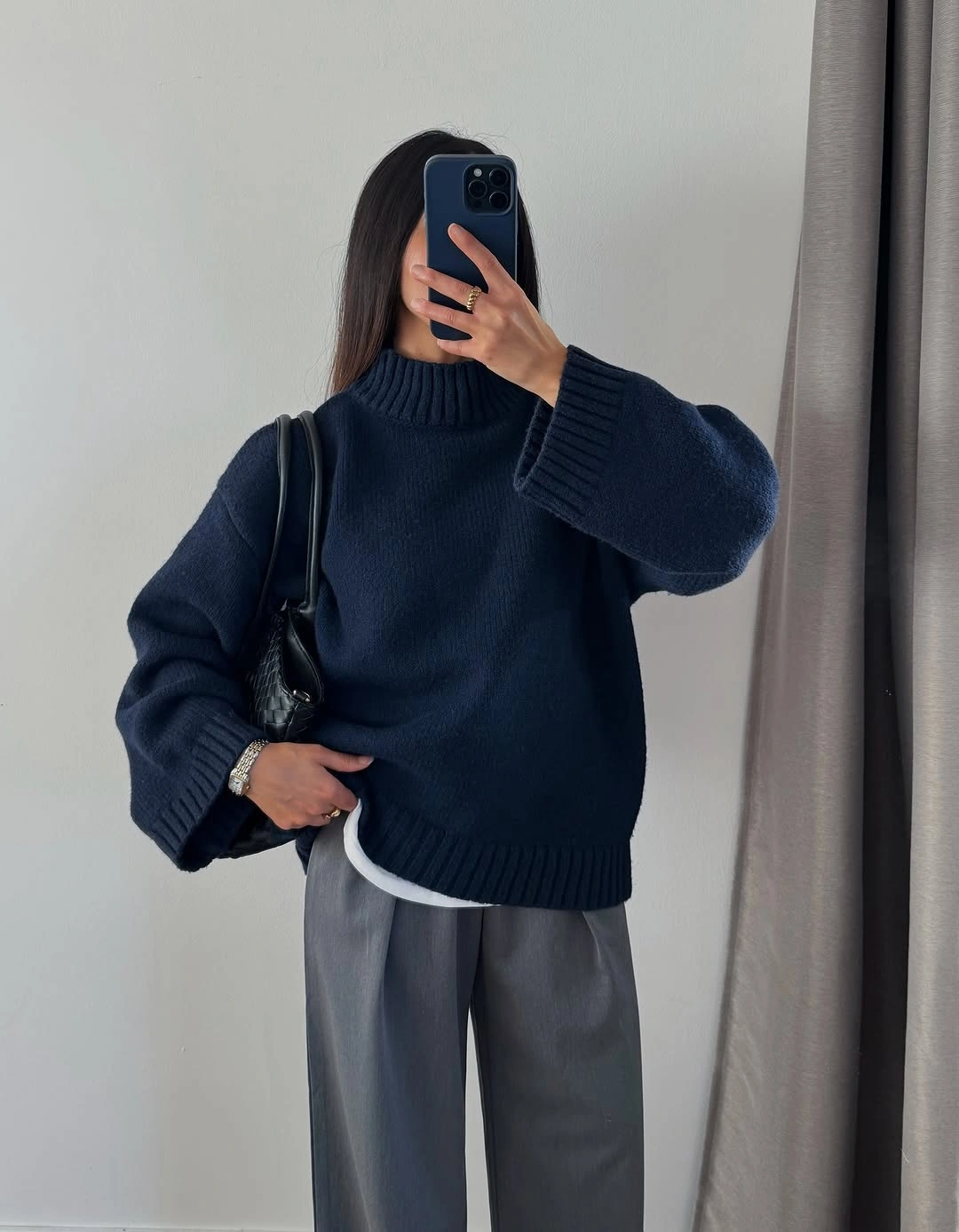 Thick navy sweater with gray pleated trousers for winter office style