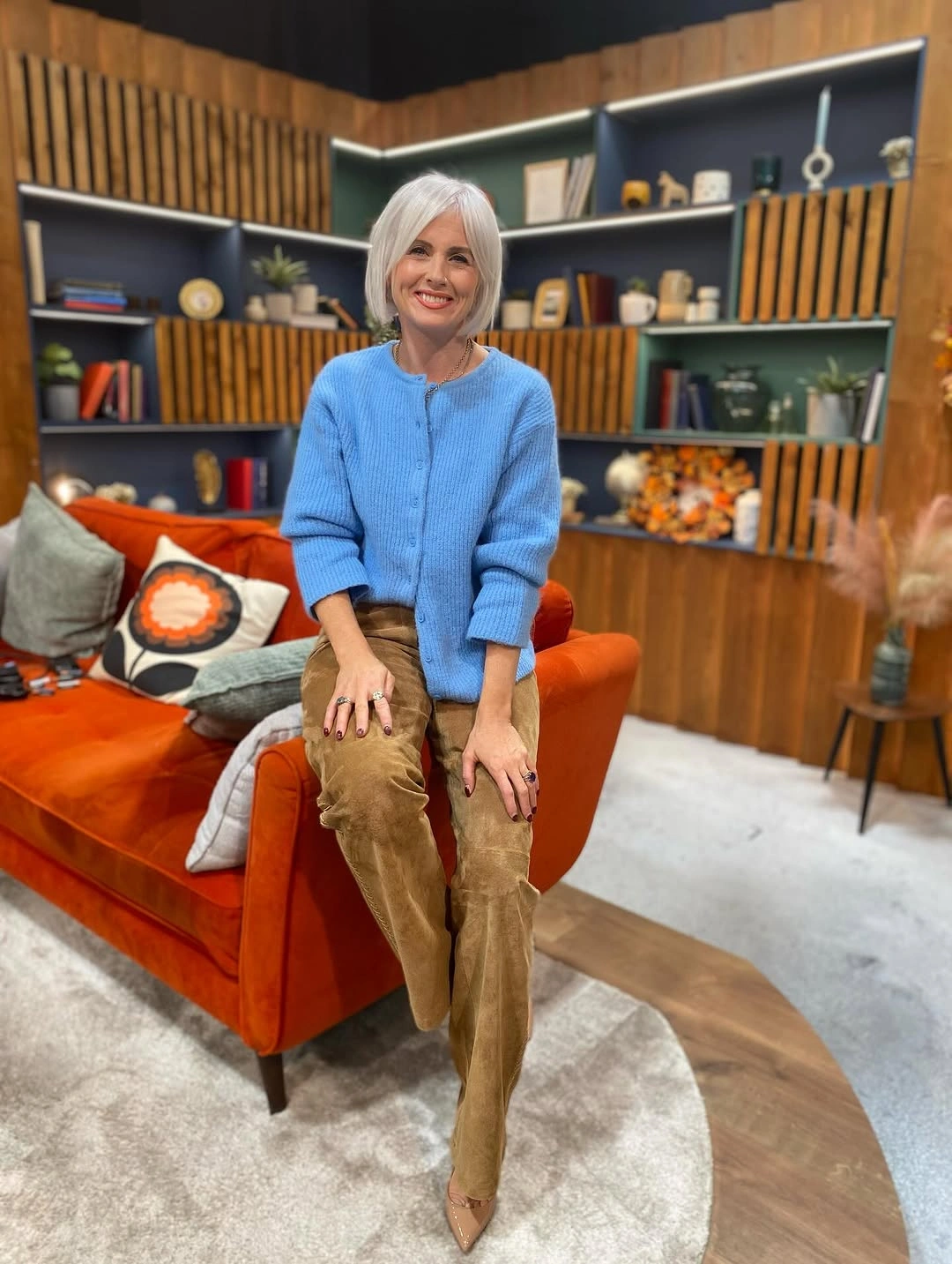 Bright blue sweater with camel high-waist trousers for winter work