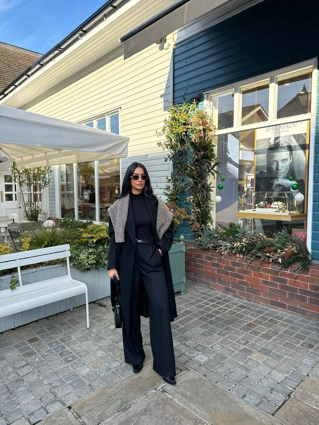 Gray blazer over black layers with dark trousers for winter work