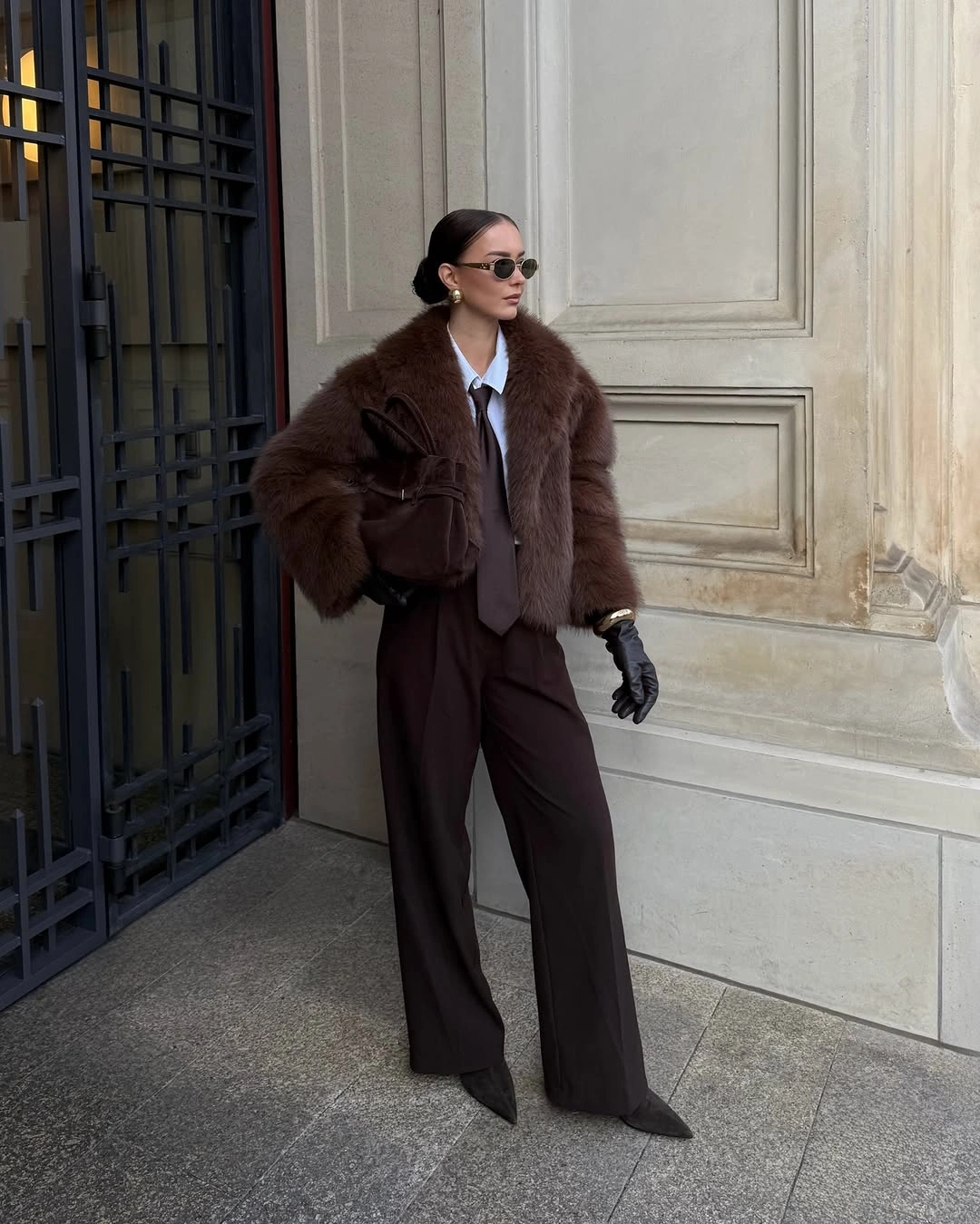 Textured brown jacket with brown trousers, gloves, and sunglasses