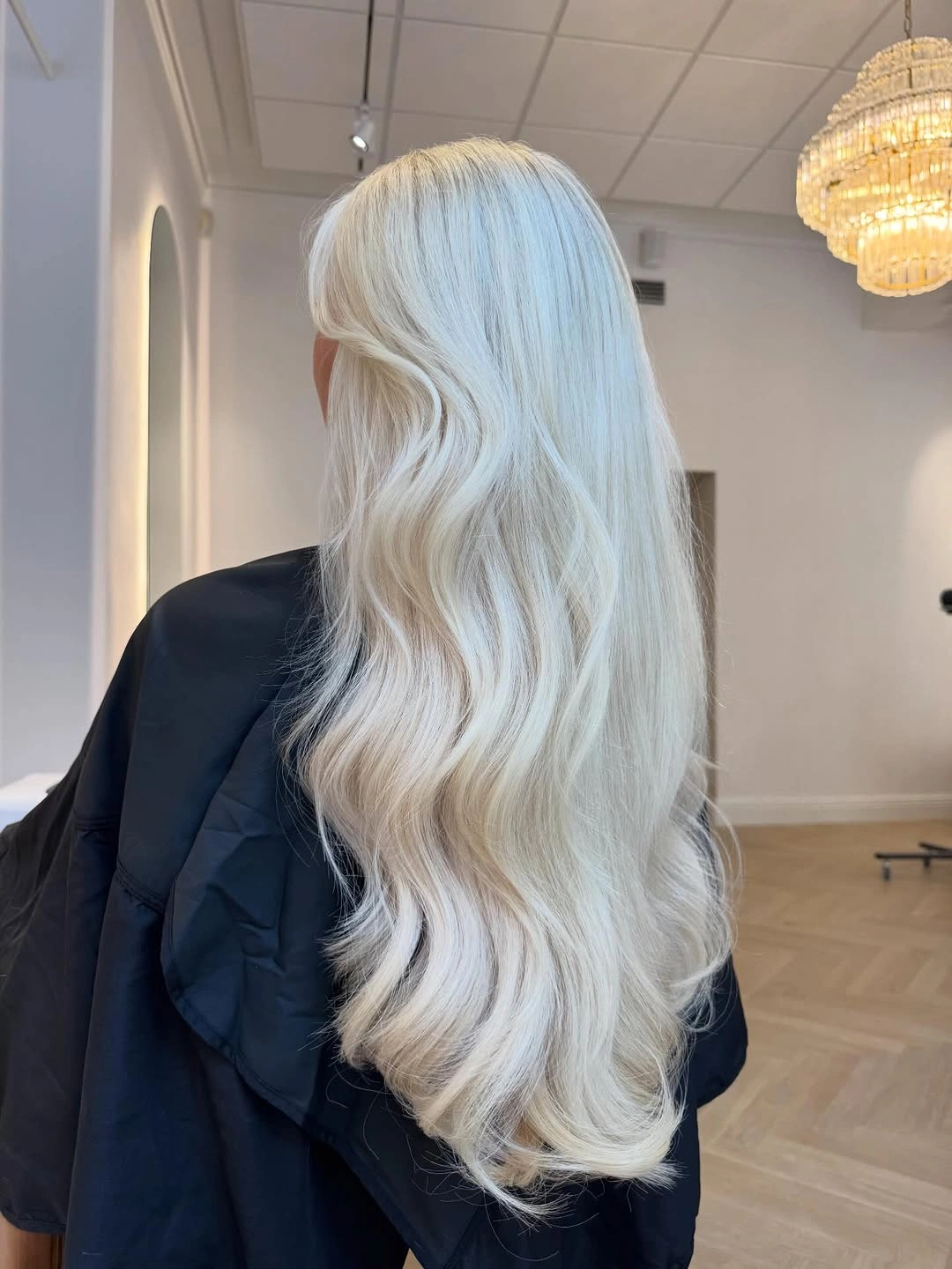 Very long icy blonde hair with loose cascading waves