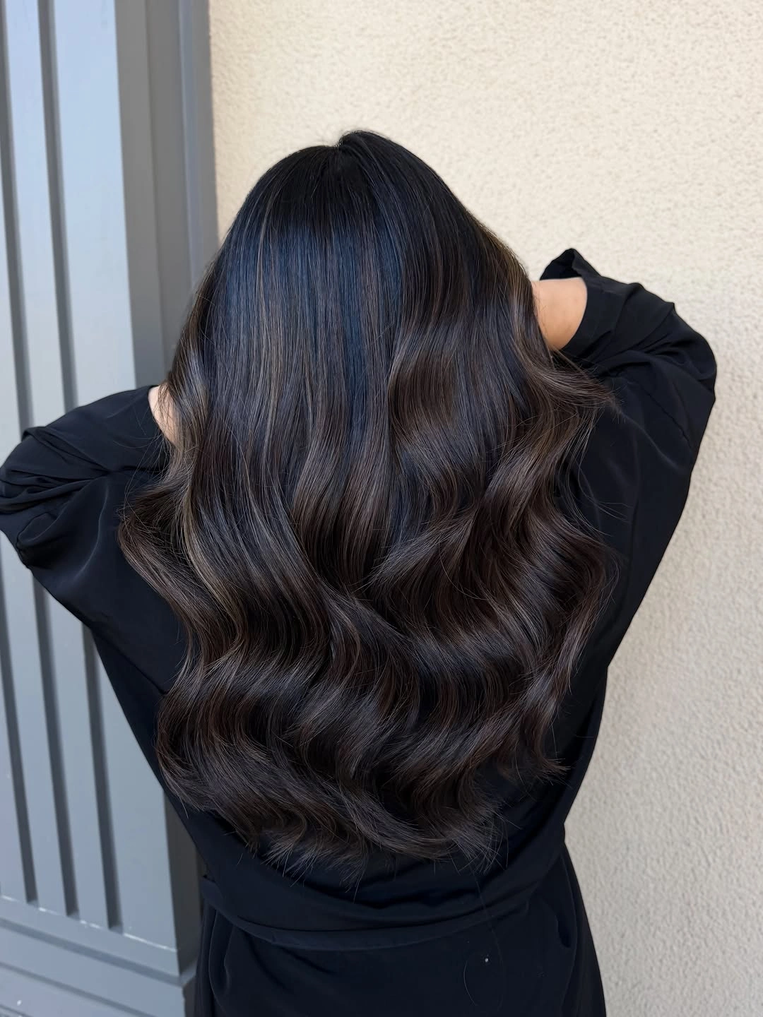 Long near-black brunette waves with subtle warm ribbons