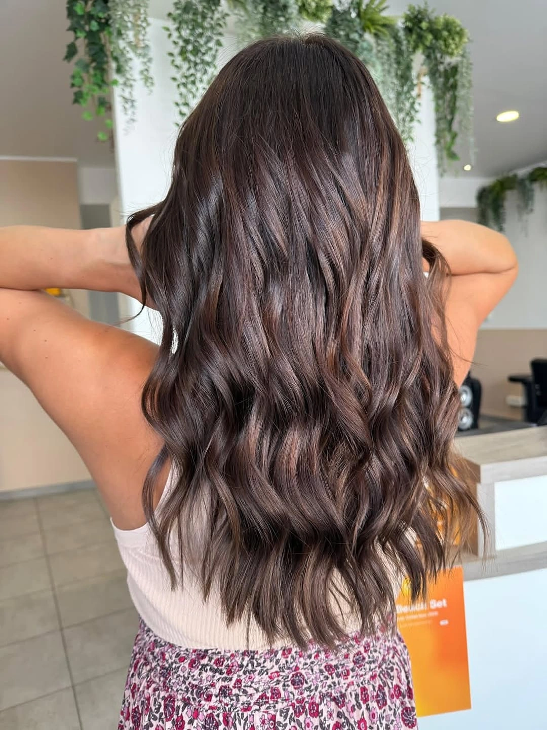 Long brunette waves with muted rose-brown and mauve sheen