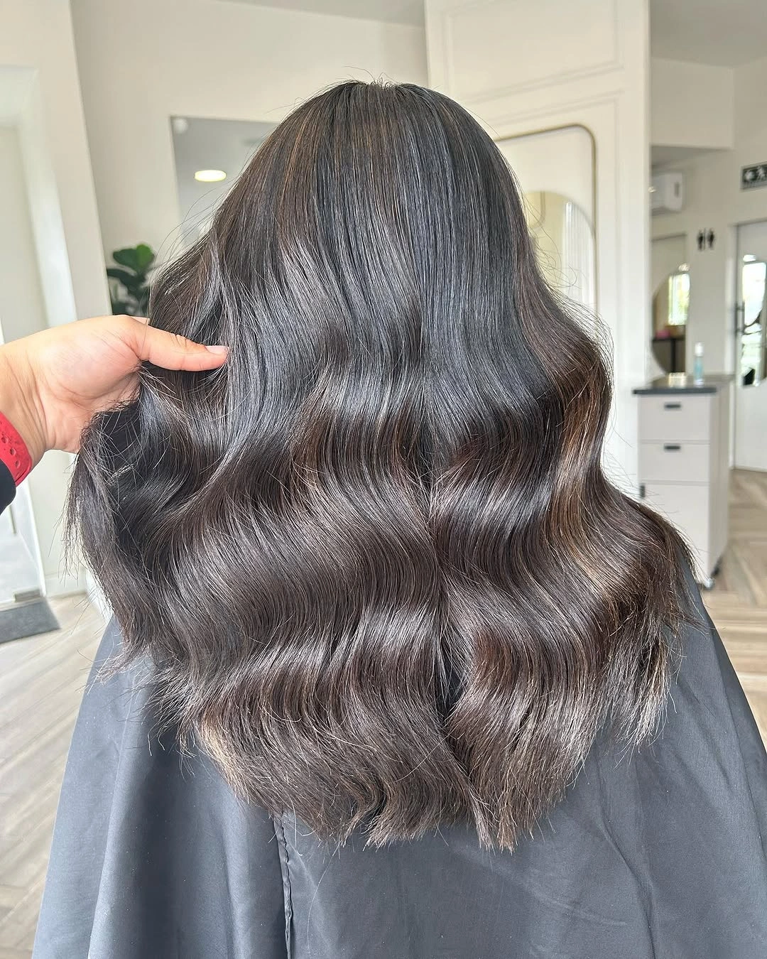 Medium brunette waves with smoky cool surface shine