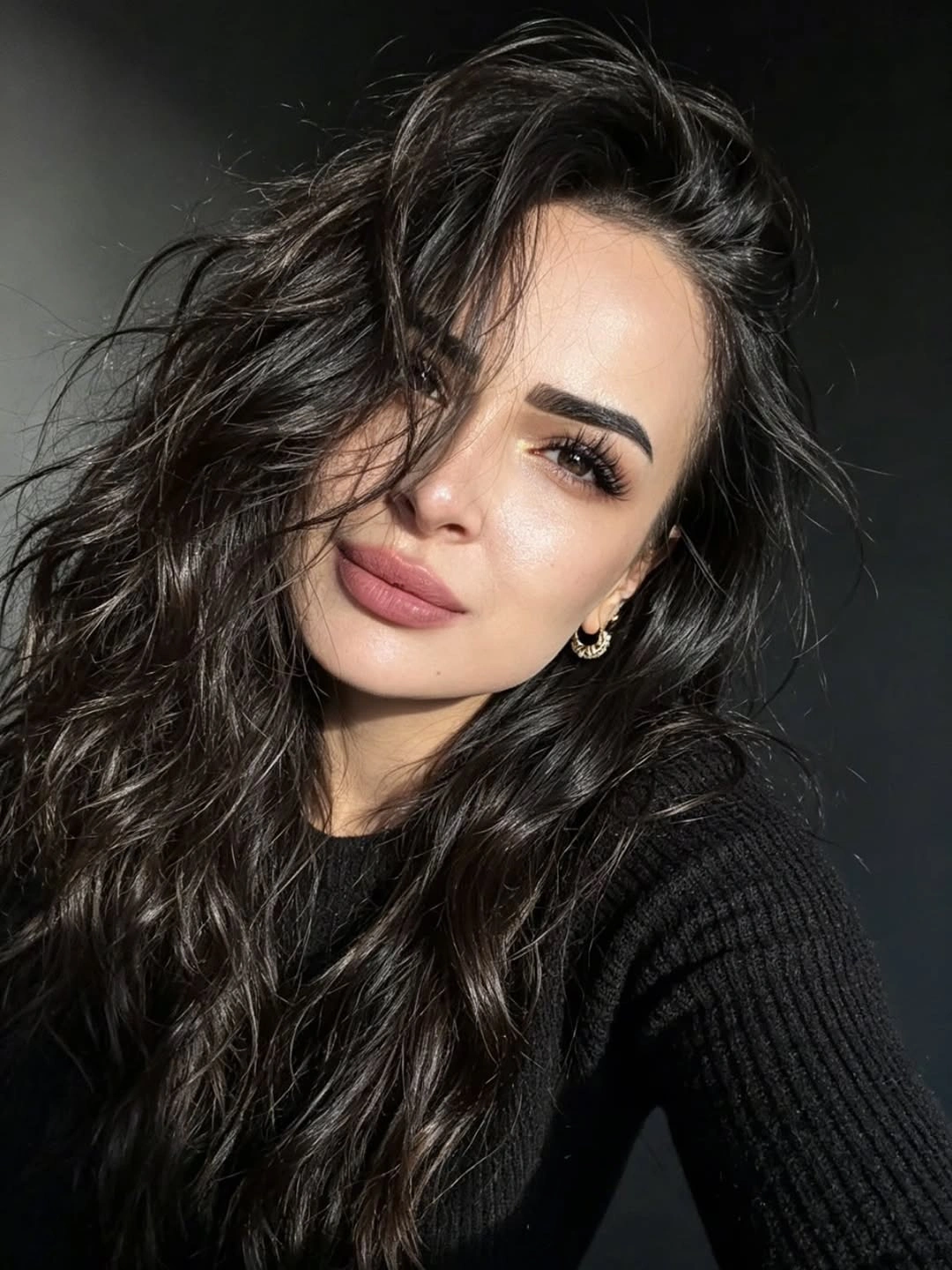 Long near-black brunette waves with side part and glossy bends