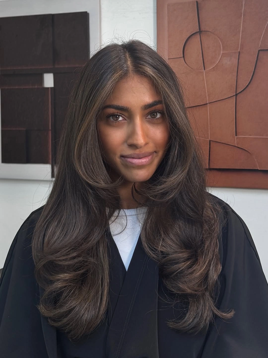 Long dark brunette layers with soft face-framing pieces