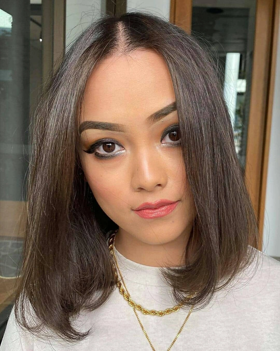 Medium straight brunette hair with cool beige-gray softness