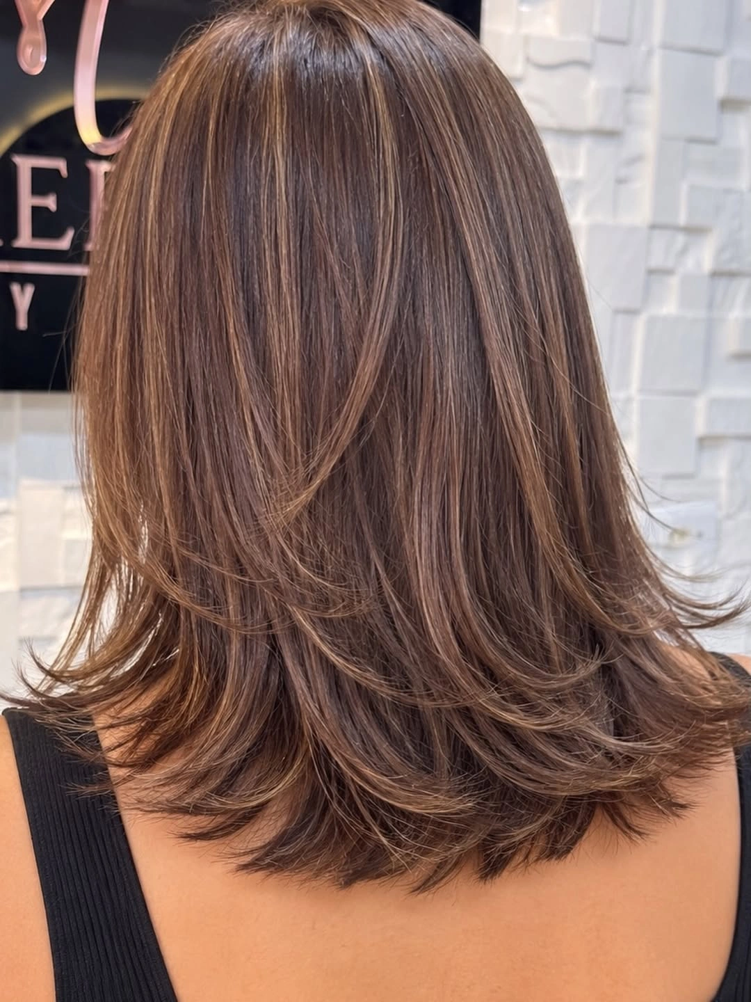 Medium chestnut brunette hair with layered flipped ends