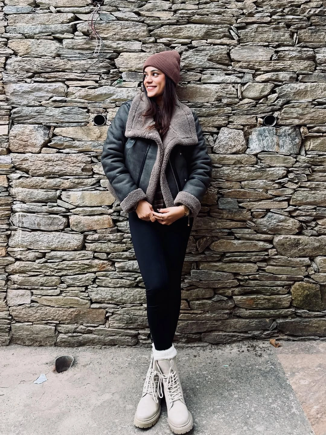 Black shearling look jacket brown beanie and pale lace up boots