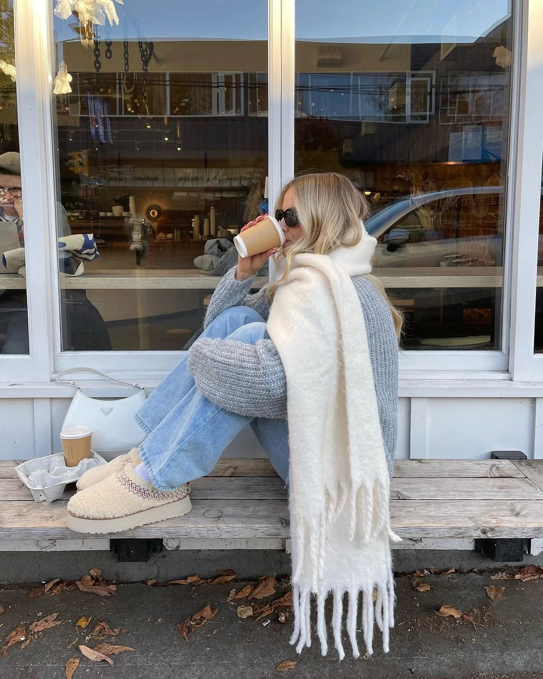 Gray chunky knit white scarf pale jeans and cream boots