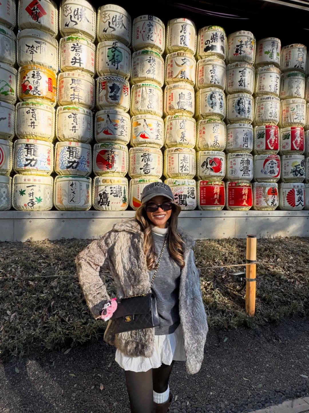 Gray cap sunglasses partial gray top before sake barrels