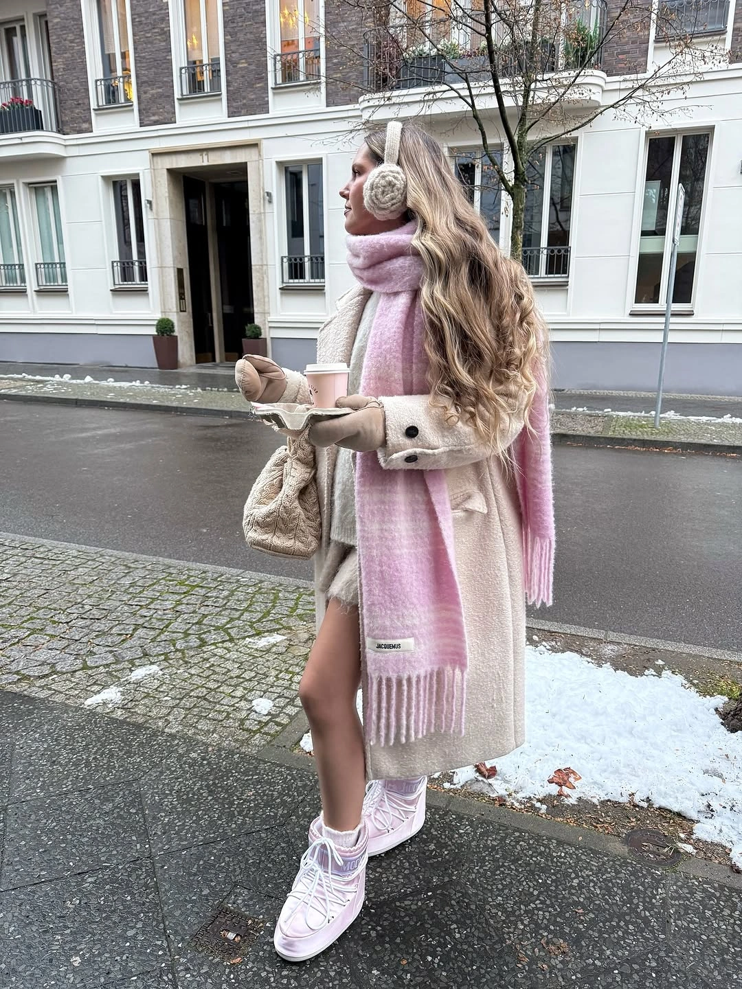 Cream long coat pink scarf earmuffs and pale pink boots