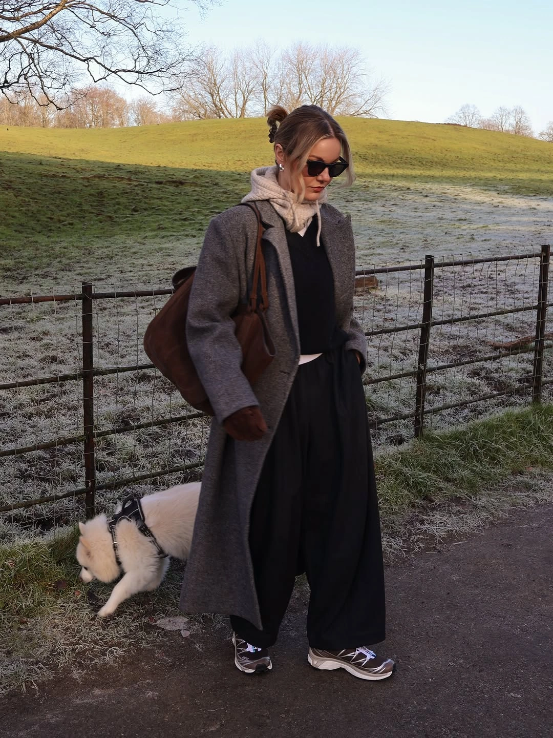 Charcoal coat, black wide trousers, beige scarf, sneakers, brown bag