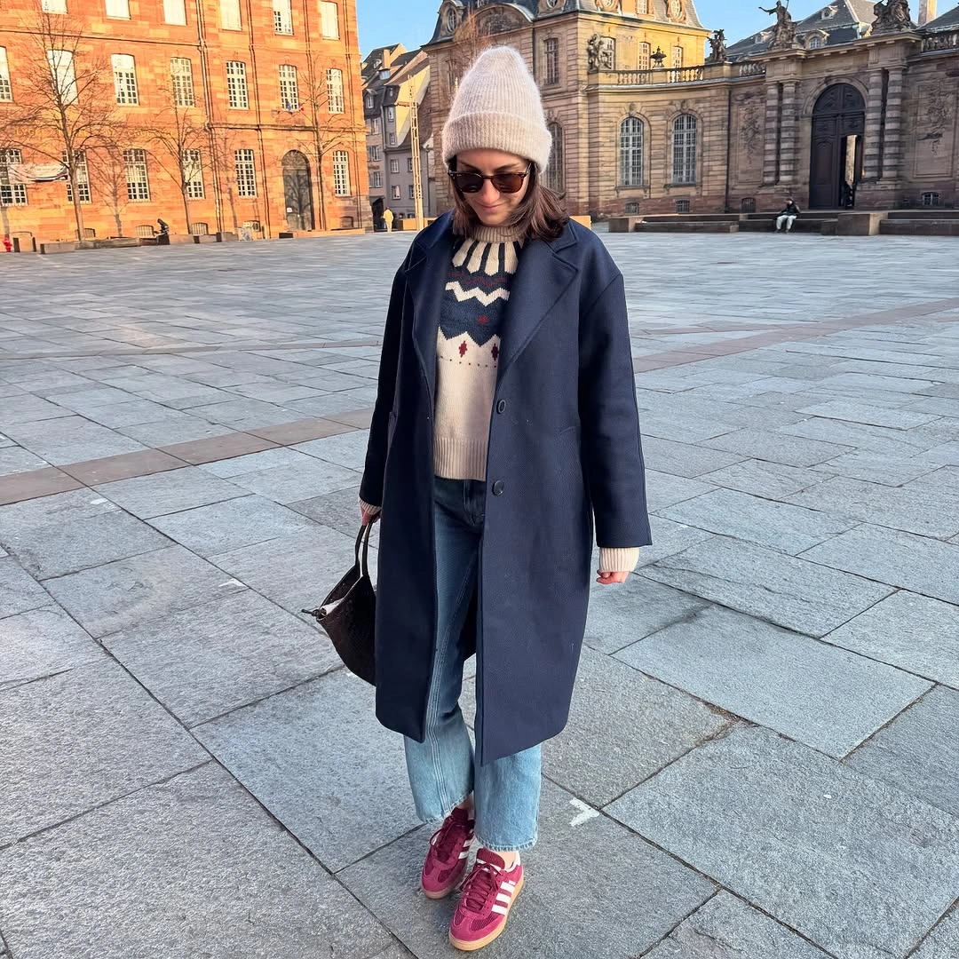 Shearling-lined jacket, simple knit, straight jeans, and boots