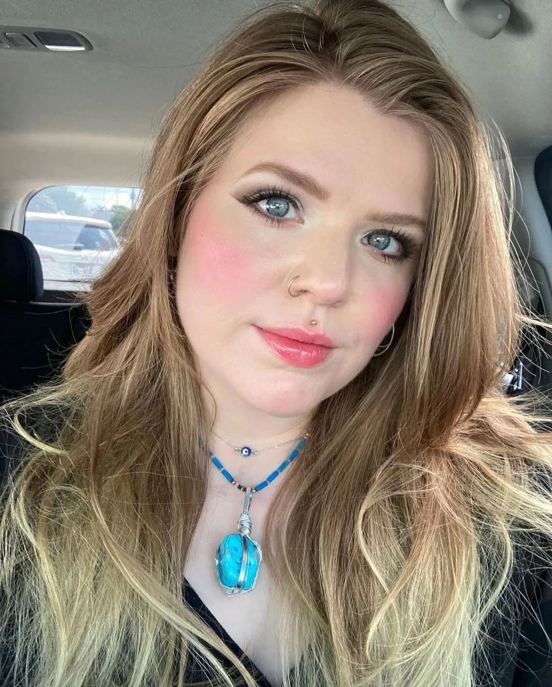 Long blonde layers with lifted side part and airy ends