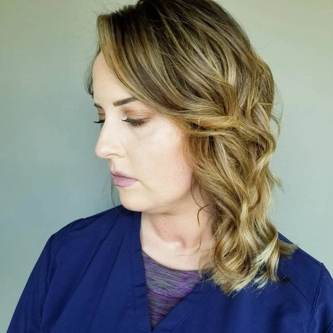 Blonde shoulder-length waves with side part and curled layers