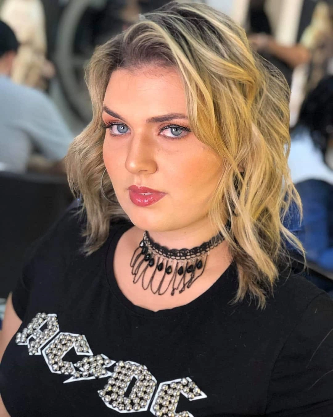 Shoulder-length blonde wavy lob with deep side part