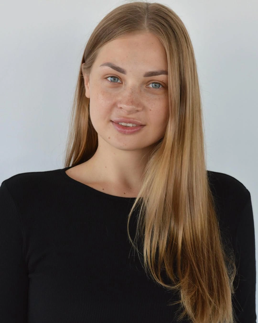Very long straight blonde hair with center part