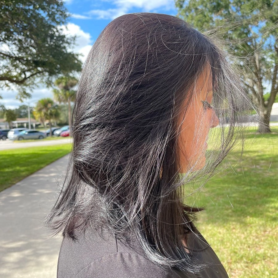 Shoulder-length dark straight hair with lifted layered ends