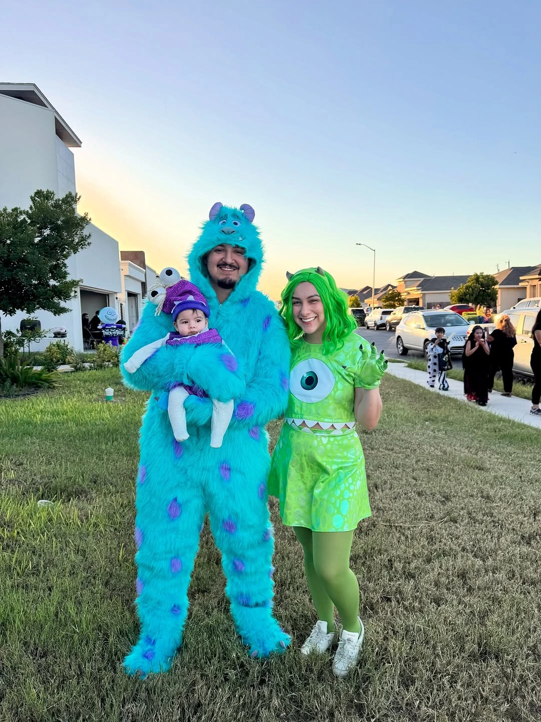 Family in blue fuzzy and neon green monster costumes