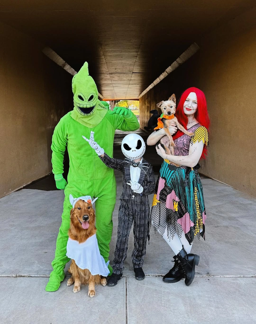 Family with lime green character skeleton costume and dog