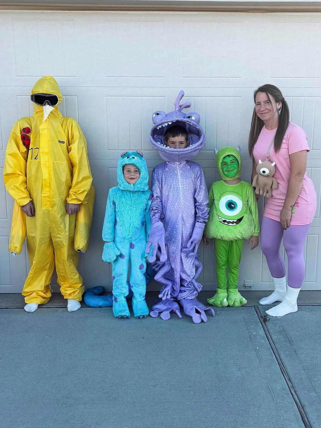 Family in yellow blue purple green and pink cartoon costumes