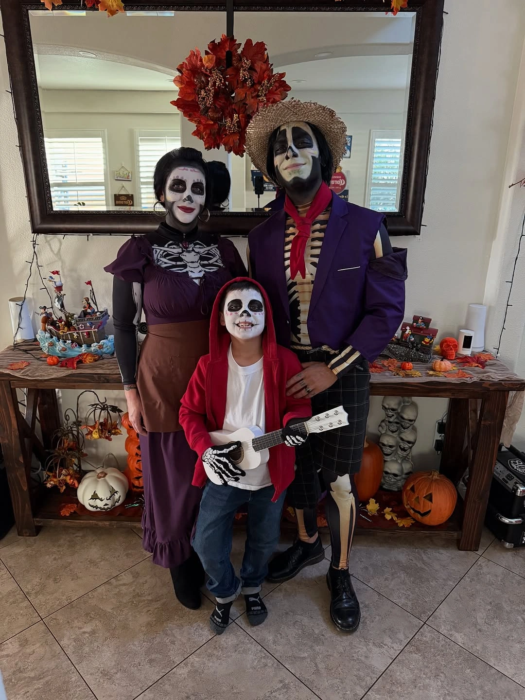 Family in formal skeleton makeup with purple and dark costumes