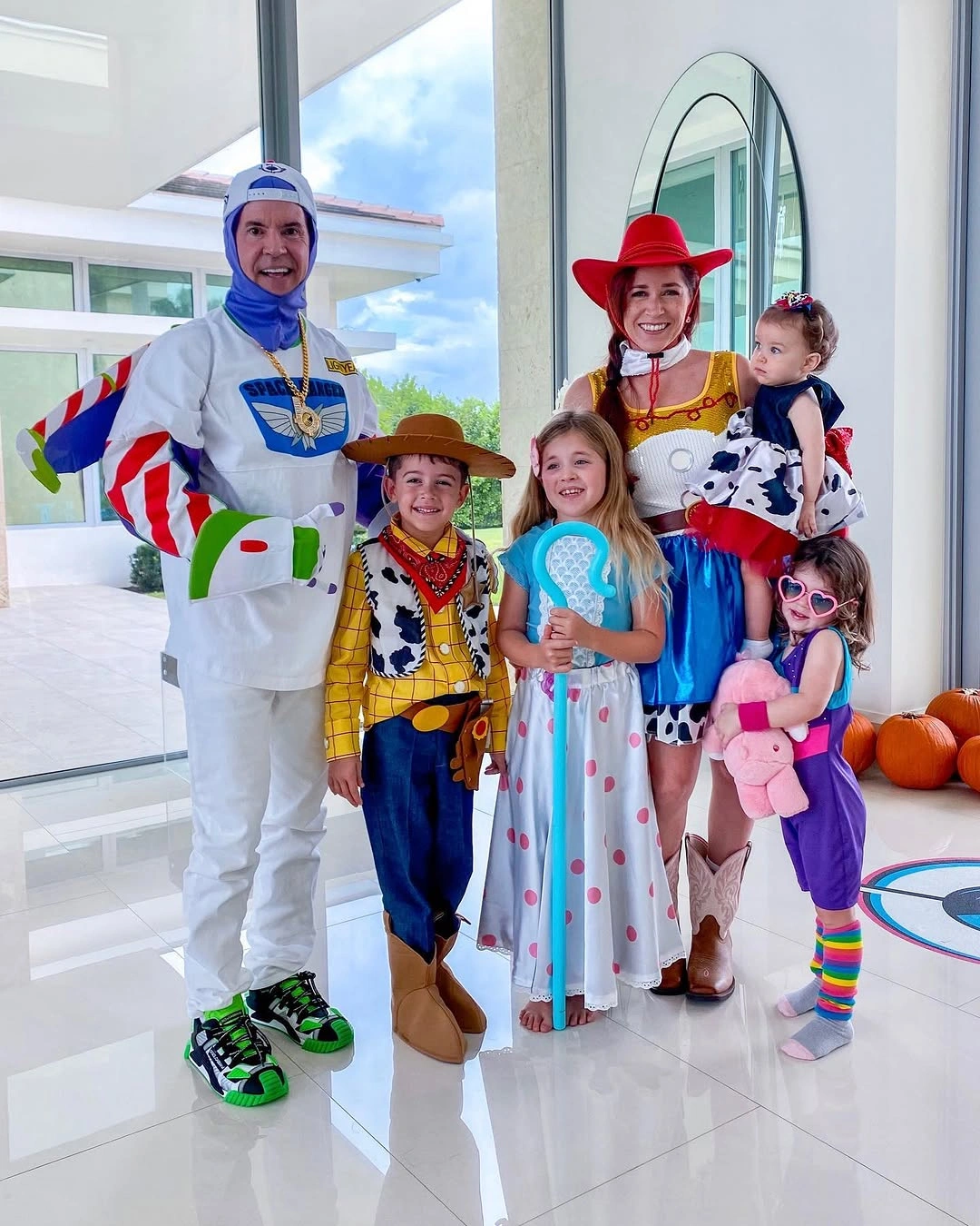 Large family in astronaut cowboy cowgirl and toy character costumes