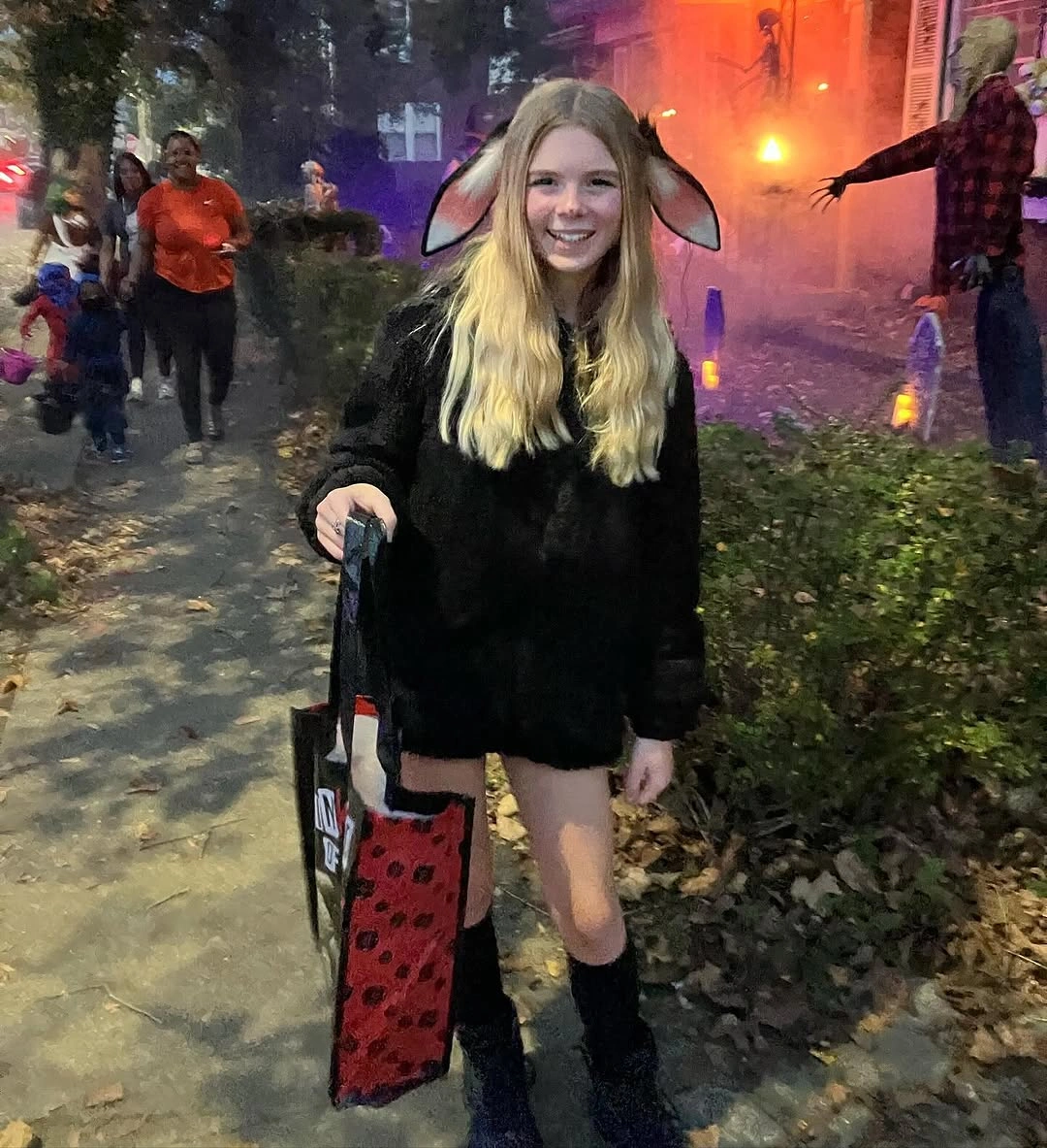 Girl in black cape with animal ears and black boots