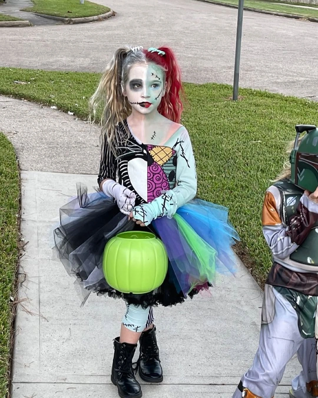 Girl in skeletal bodice rainbow tulle skirt and green pumpkin bucket