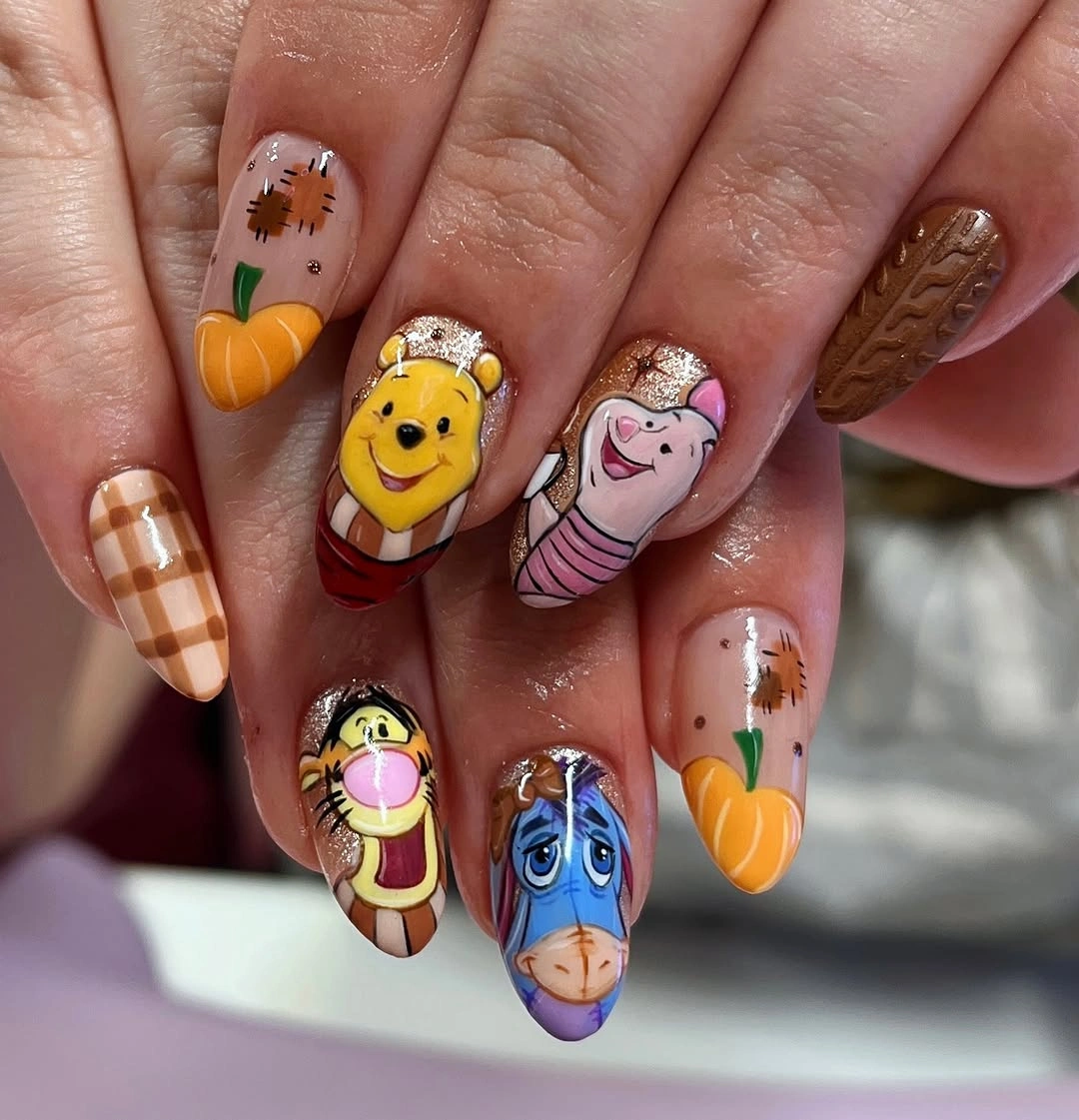 Long nude square nails with pumpkin plaid and cartoon characters