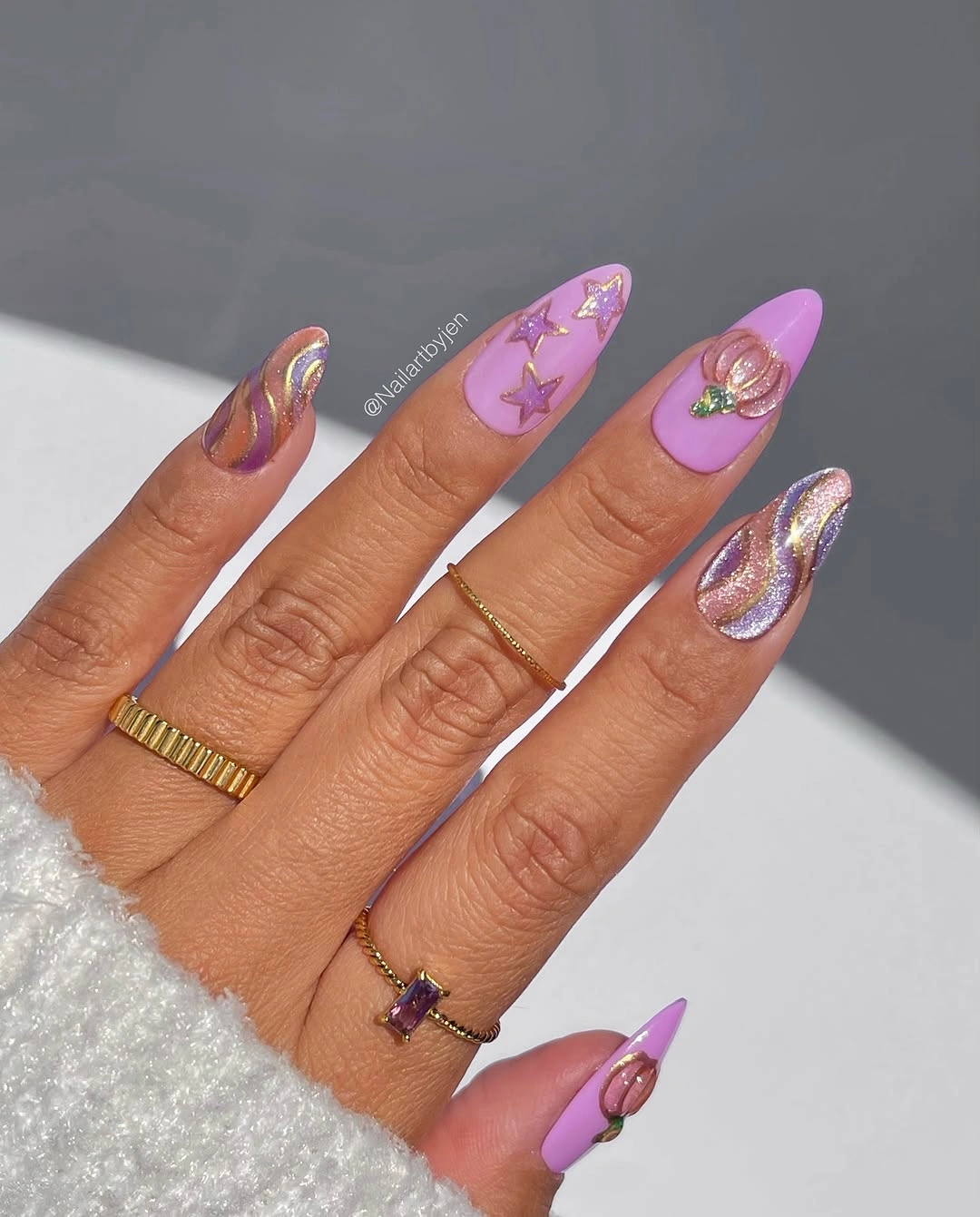 Long almond lavender nails with chrome highlights yellow stars and swirls