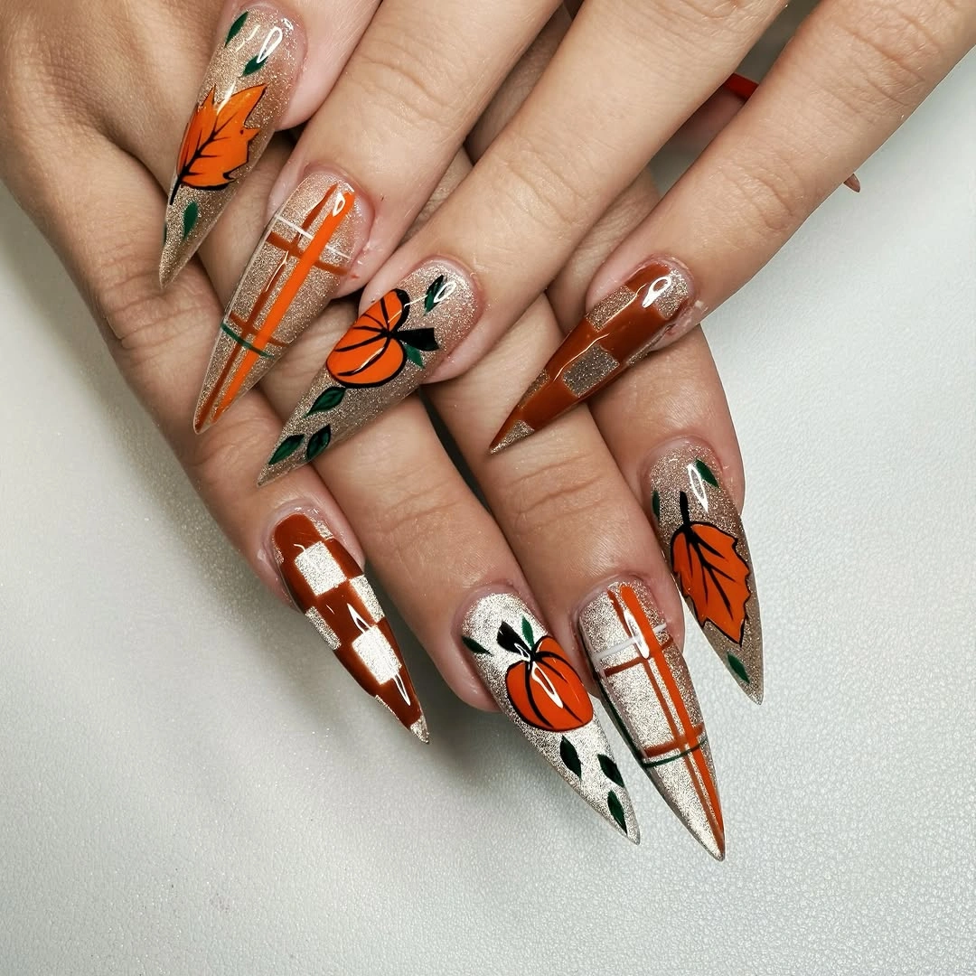 Pointed Halloween nails with pumpkins ghosts and silver glitter