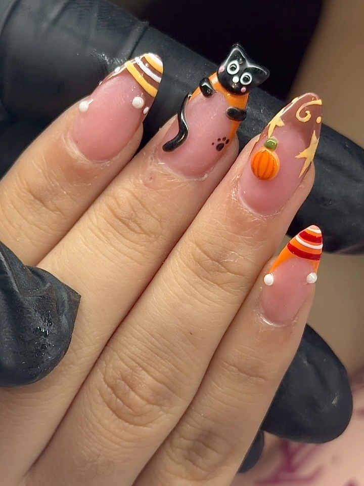 Long nude nails with candy corn black cat pumpkin and swirls