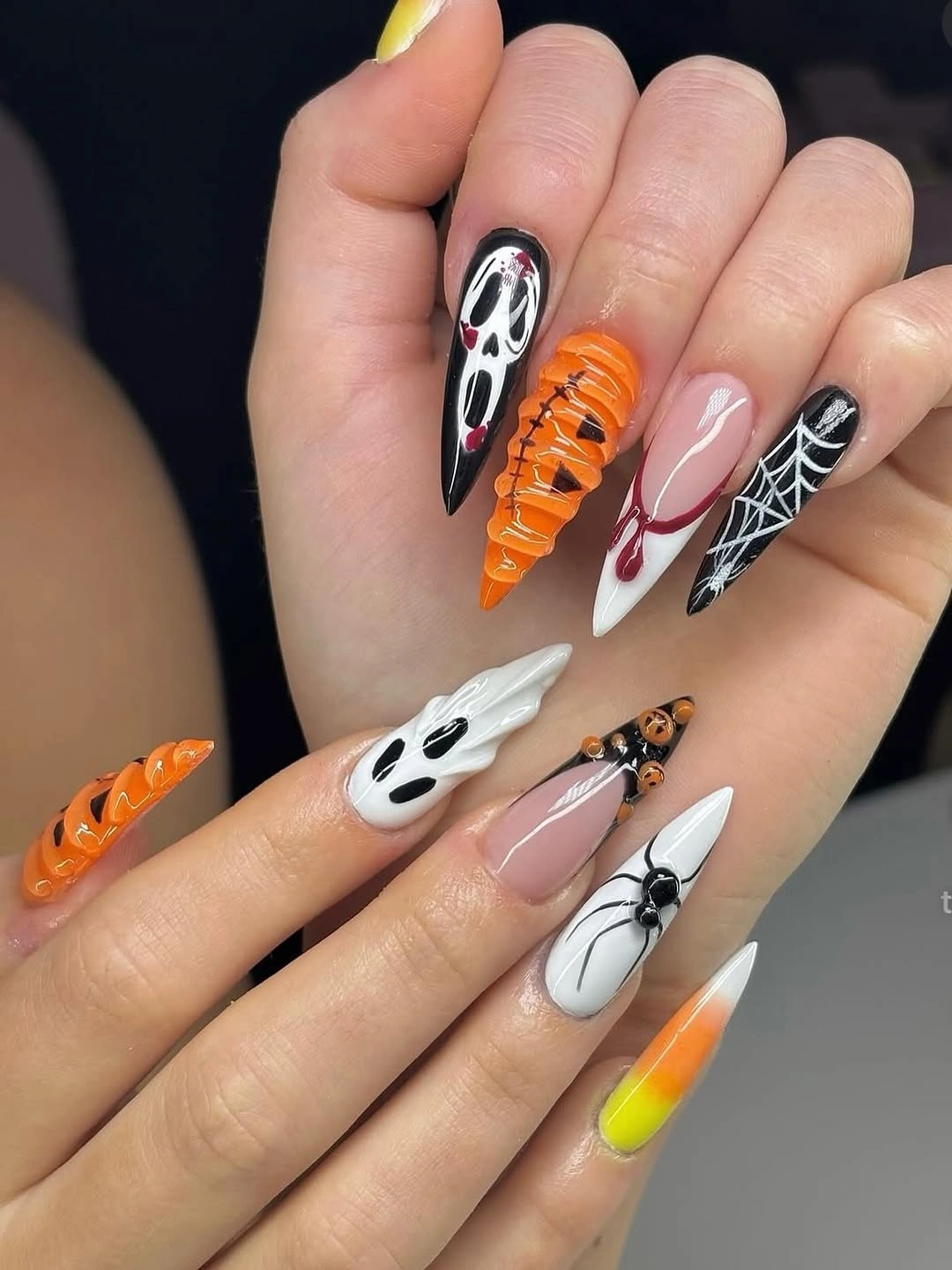Long stiletto Halloween nails with ghosts mummies and webs
