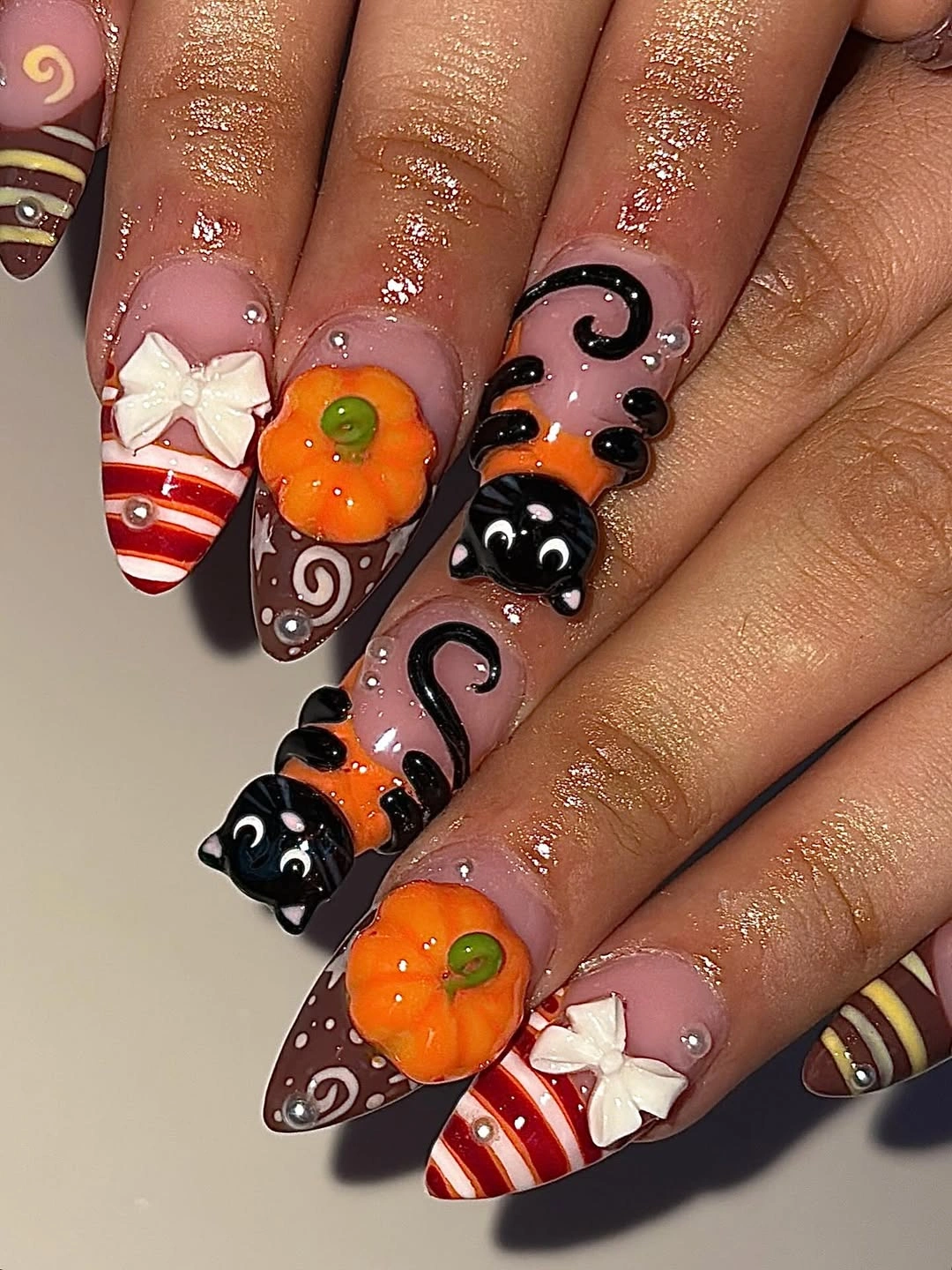 Long sculpted nails with raised pumpkins black cats and candy swirls