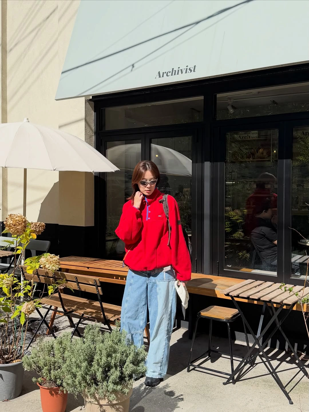 Bright red zip hoodie loose light jeans black footwear