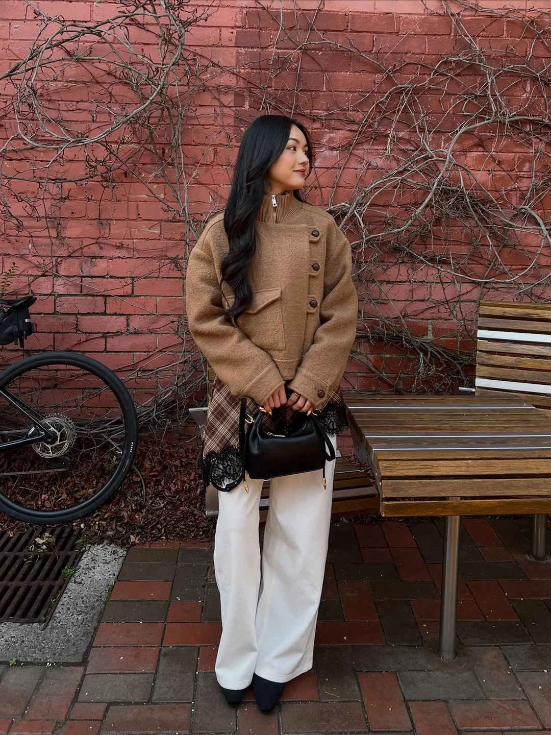 Brown buttoned jacket with plaid side layer and white trousers