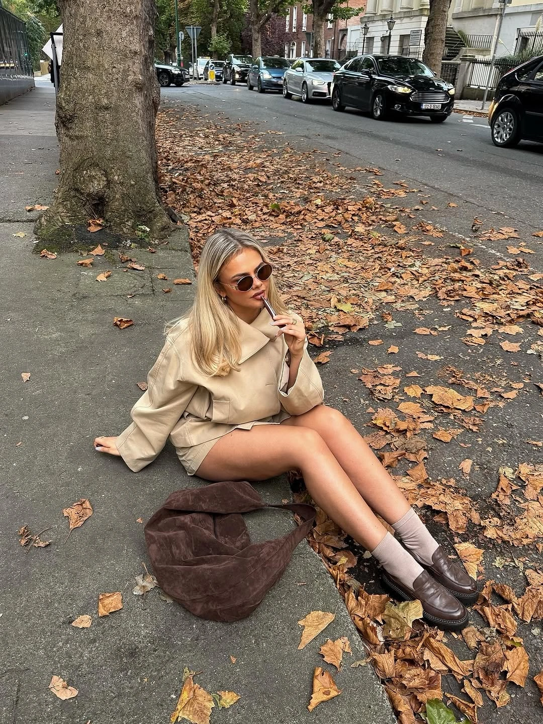 Beige cropped layer with gray socks brown loafers and large bag