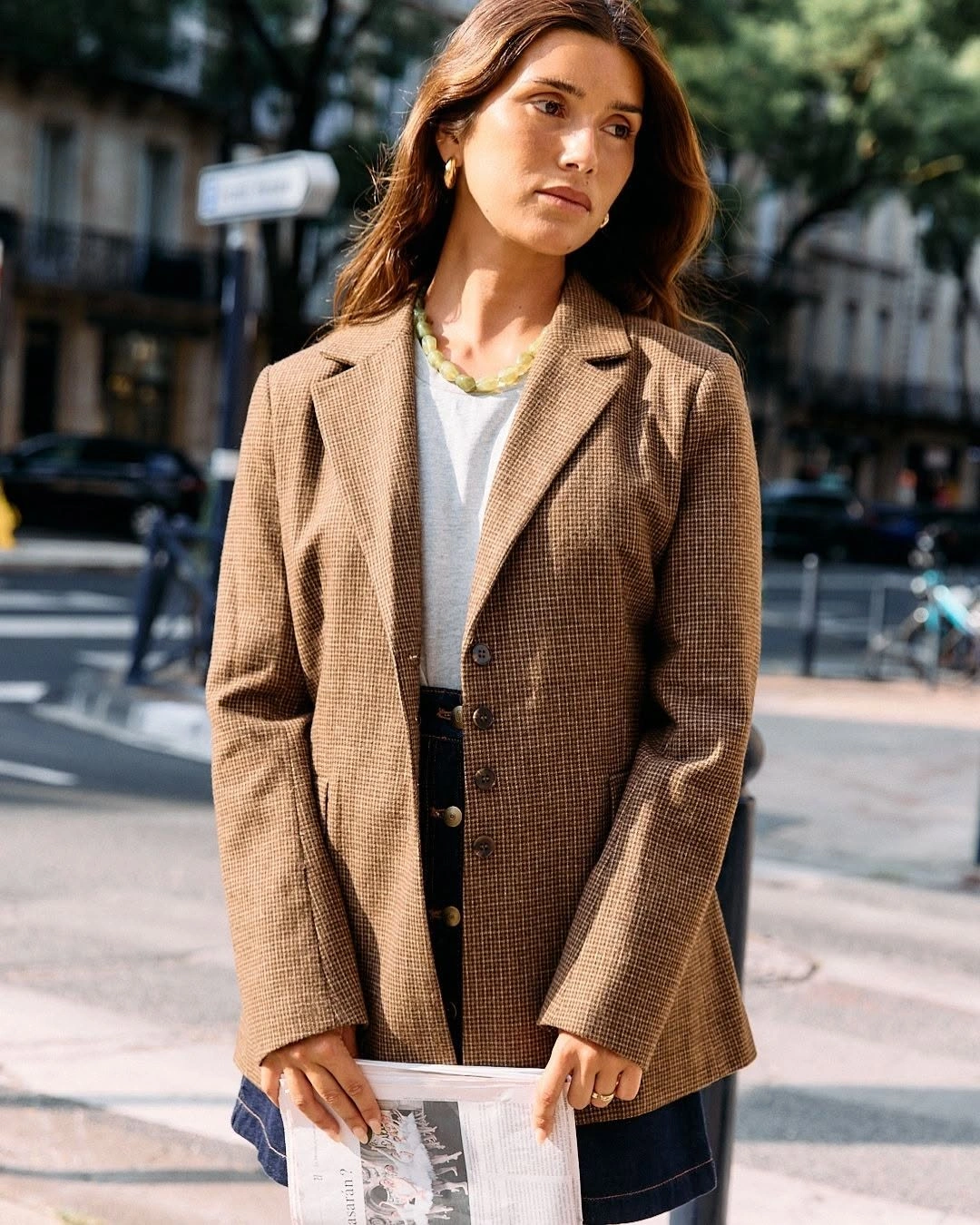 Brown fine-check blazer over white top and dark lower layer