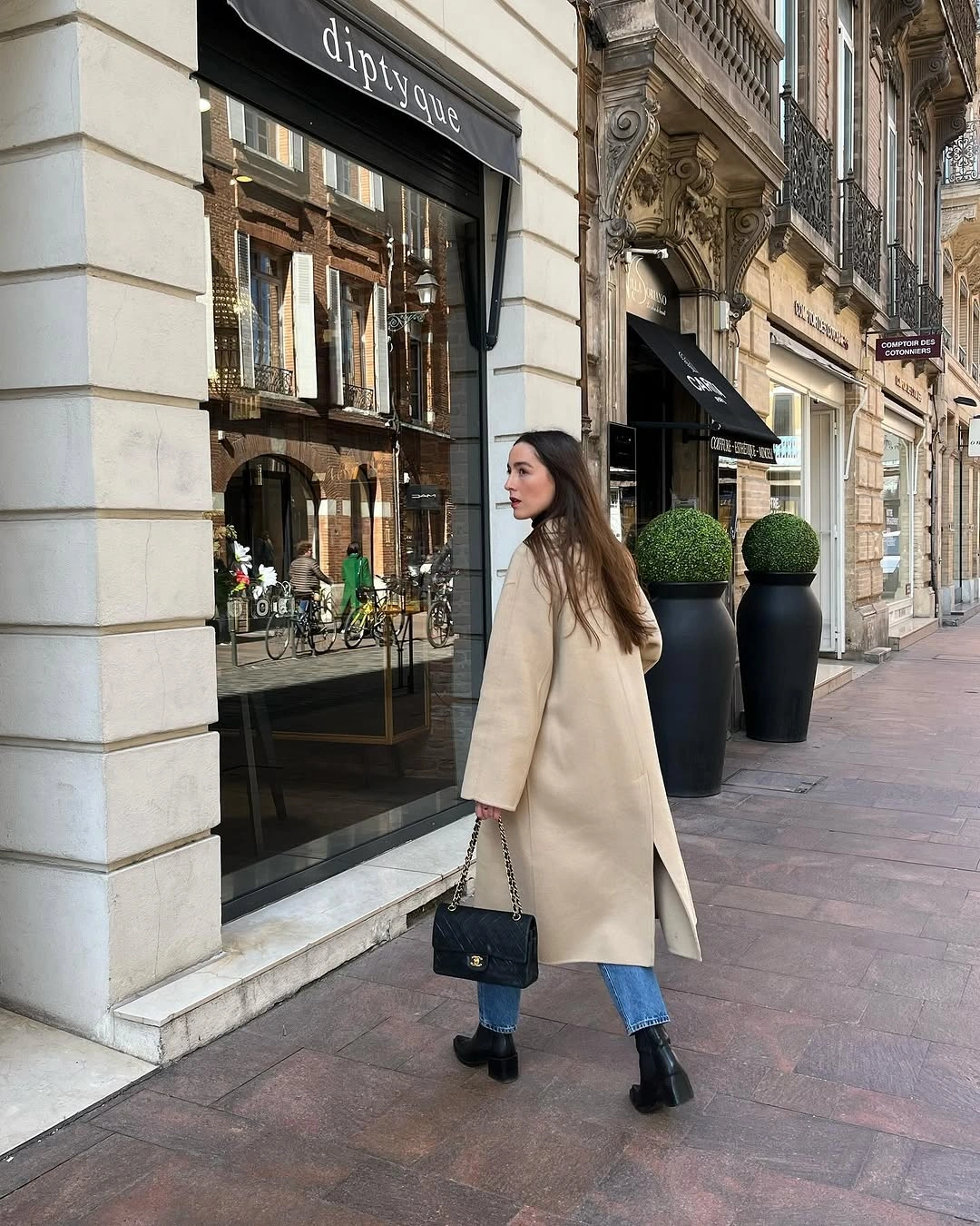 Long cream coat with cropped jeans black ankle boots