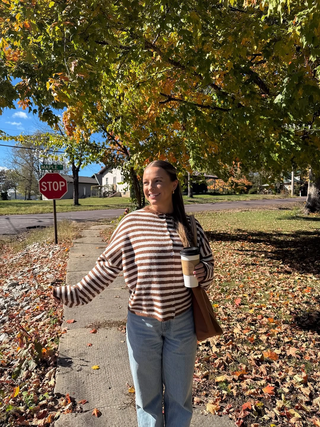 Brown and cream striped sweater with light blue jeans