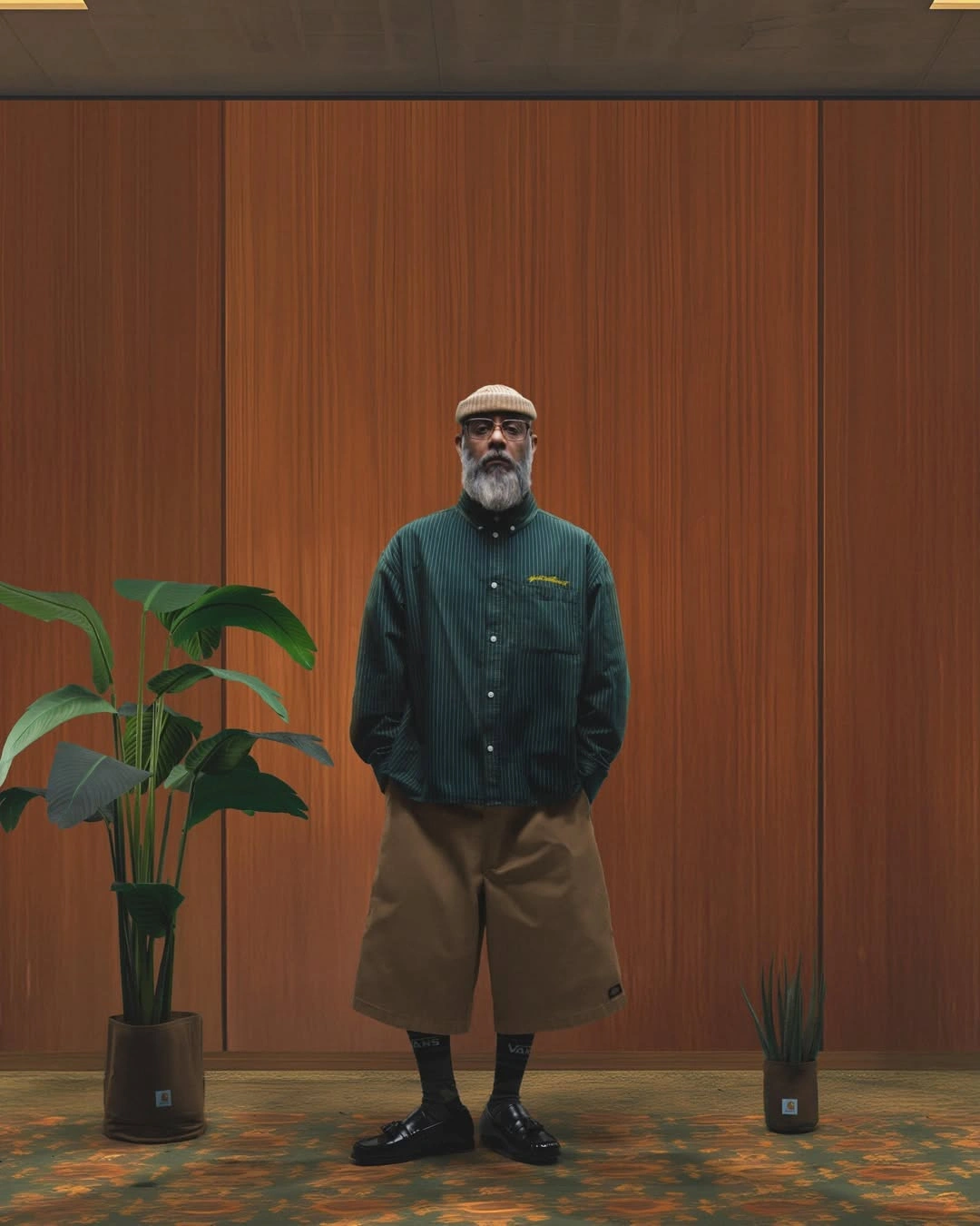 Dark green overshirt with brown shorts, socks, and black loafers