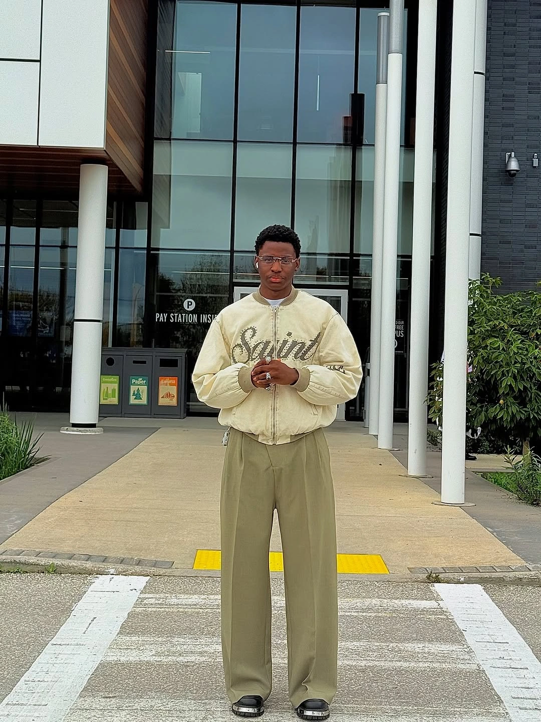 Cream graphic sweater with olive trousers and dark shoes