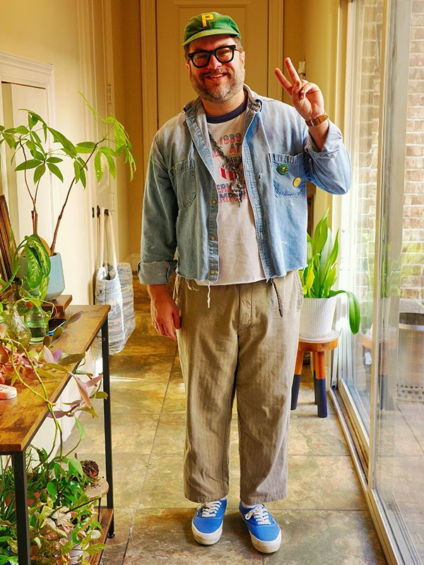 Denim jacket with tan cropped trousers and bright blue sneakers