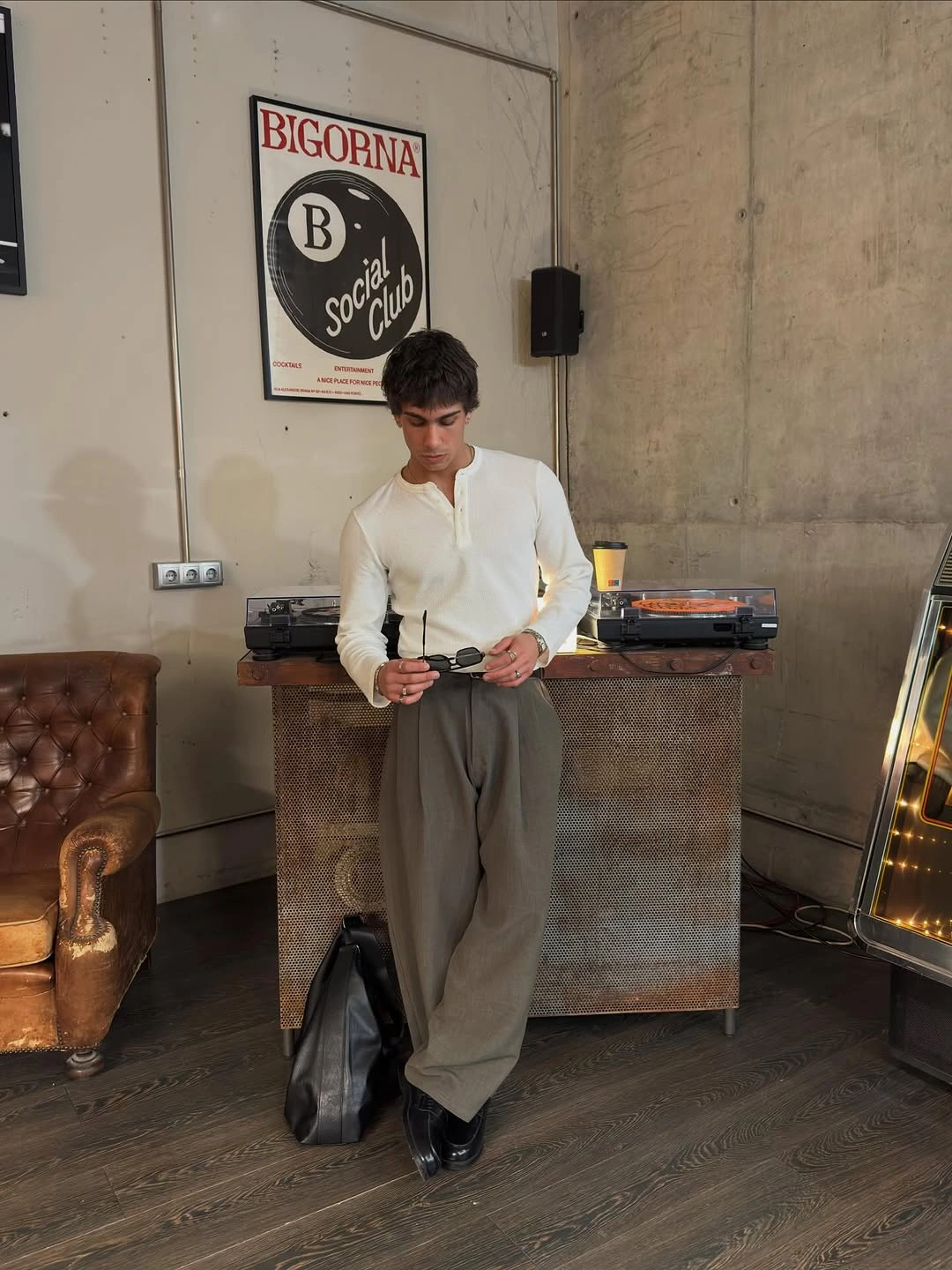 Cream cardigan with taupe pleated trousers and black shoes