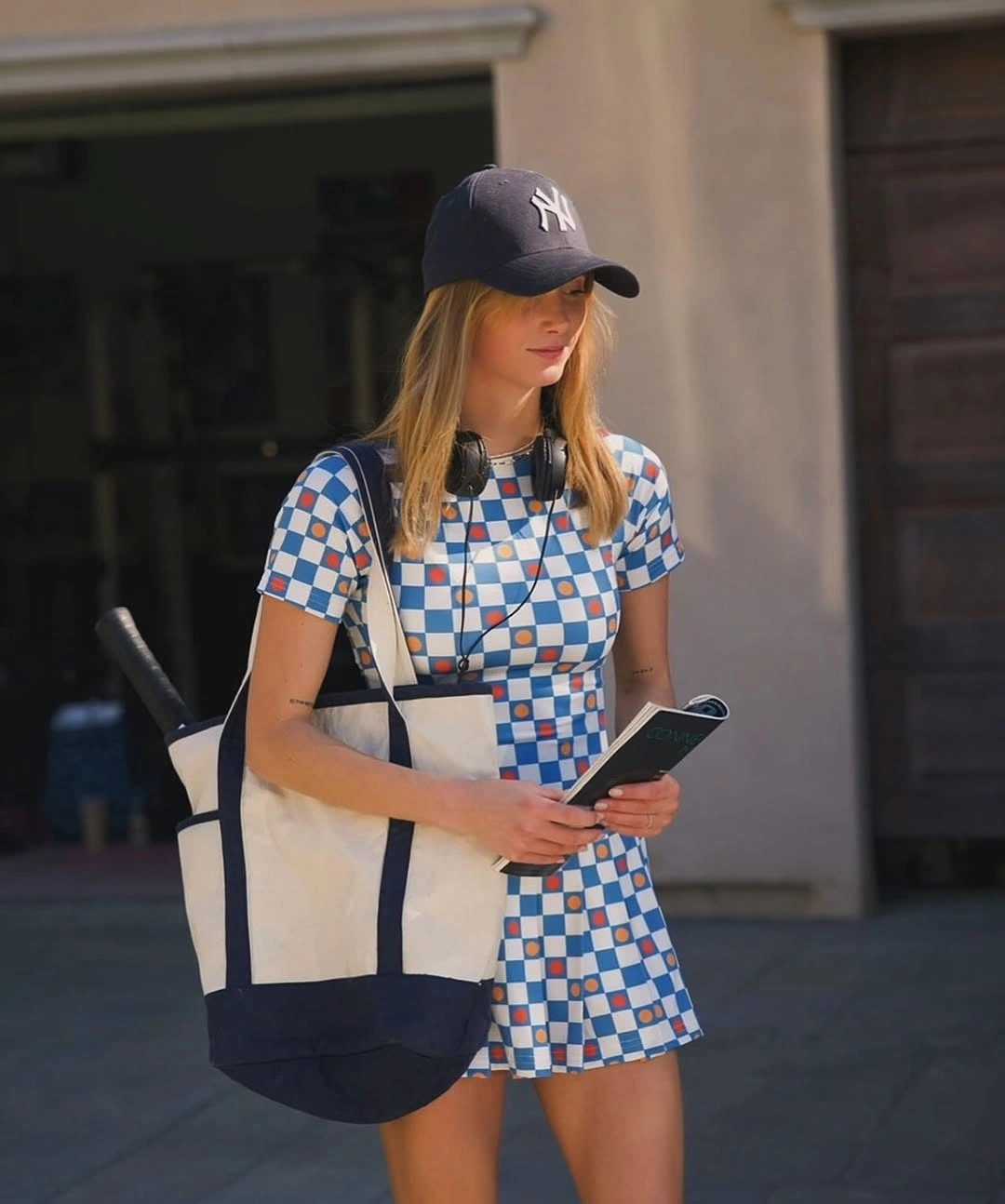 Blue check polo dress with navy cap and tote for padel