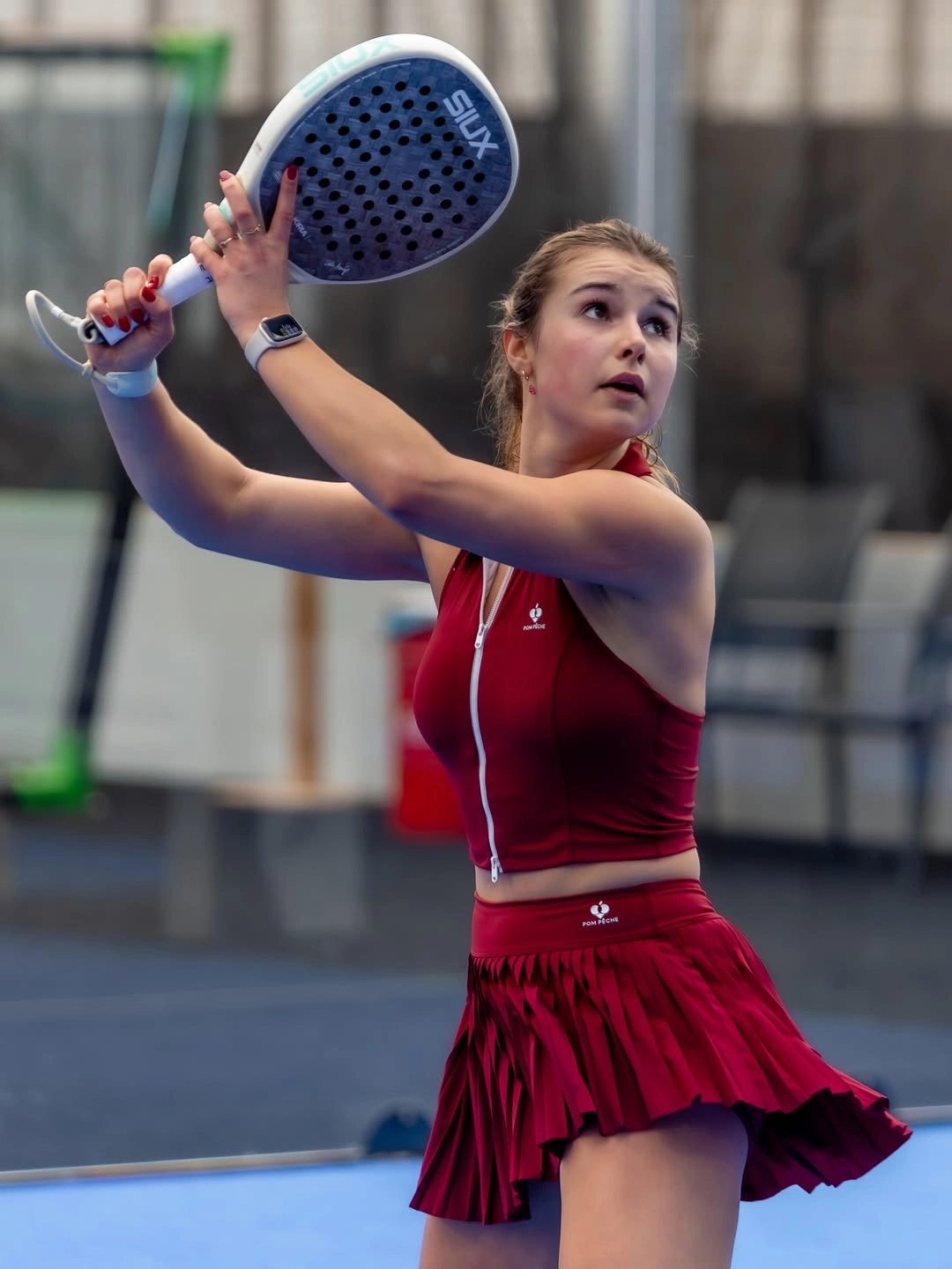 Deep red sleeveless padel set with matching skirt and white shoes