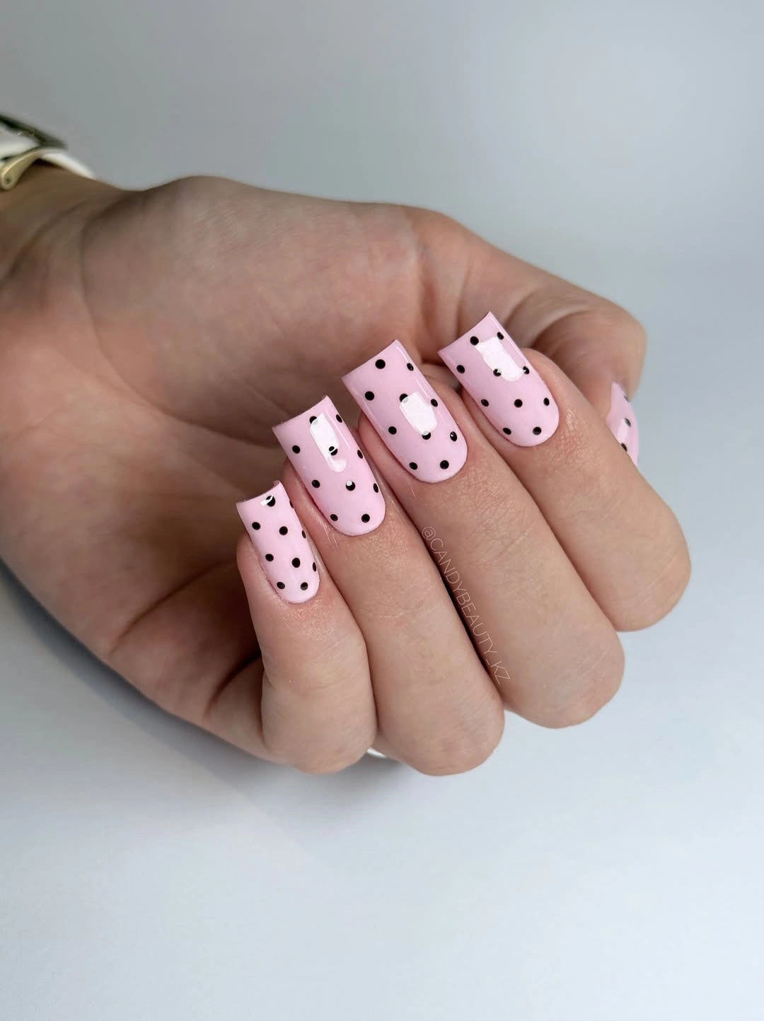 baby pink square nails with black polka dots and white flower details